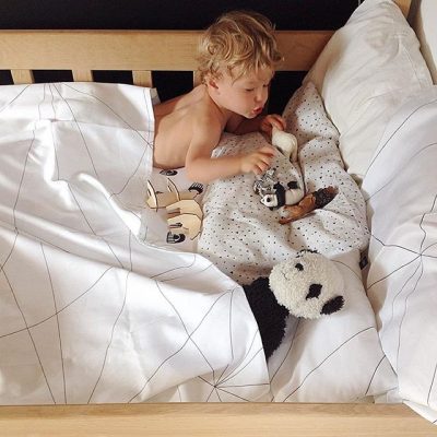 Geometric Web duvet cover with a boy on a bed