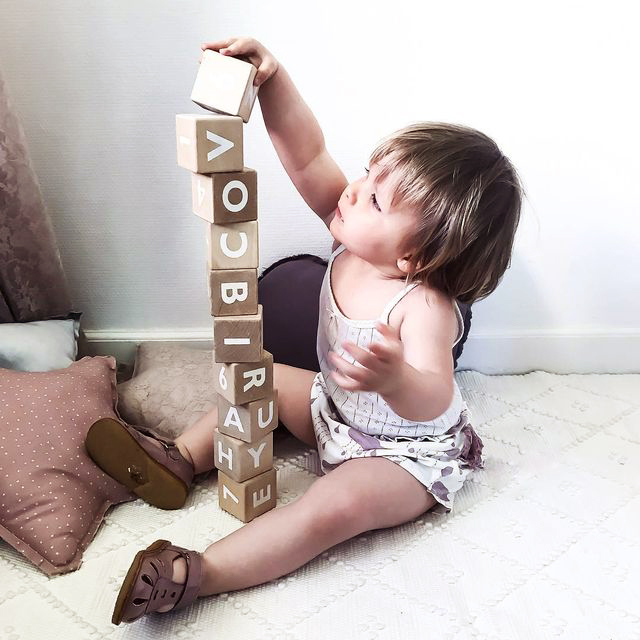 Little girl building a tower