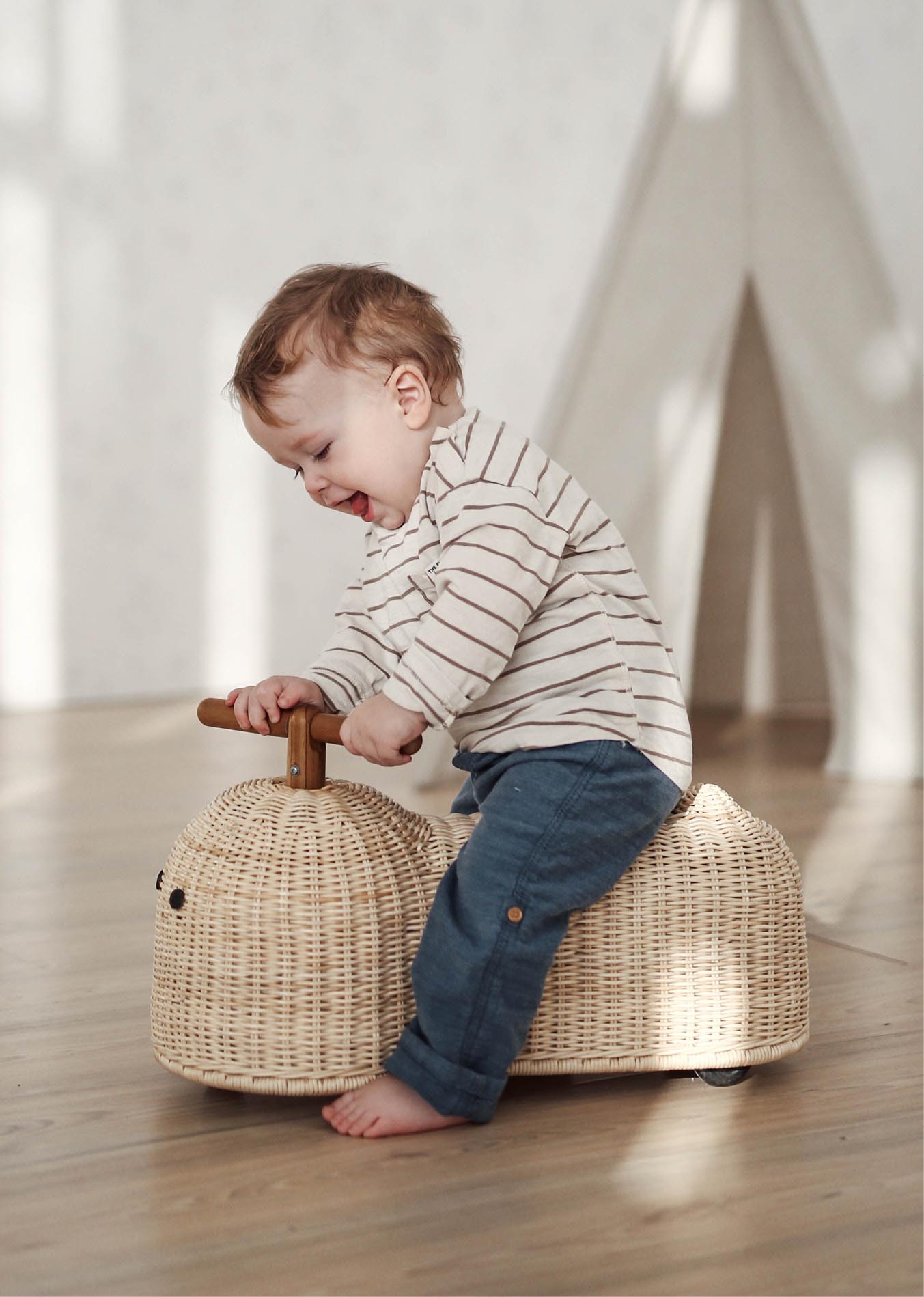 Children’s Ride-On Toys That Inspire Creativity and Movement_2 Child playing with Ride On Toy made of Rattan